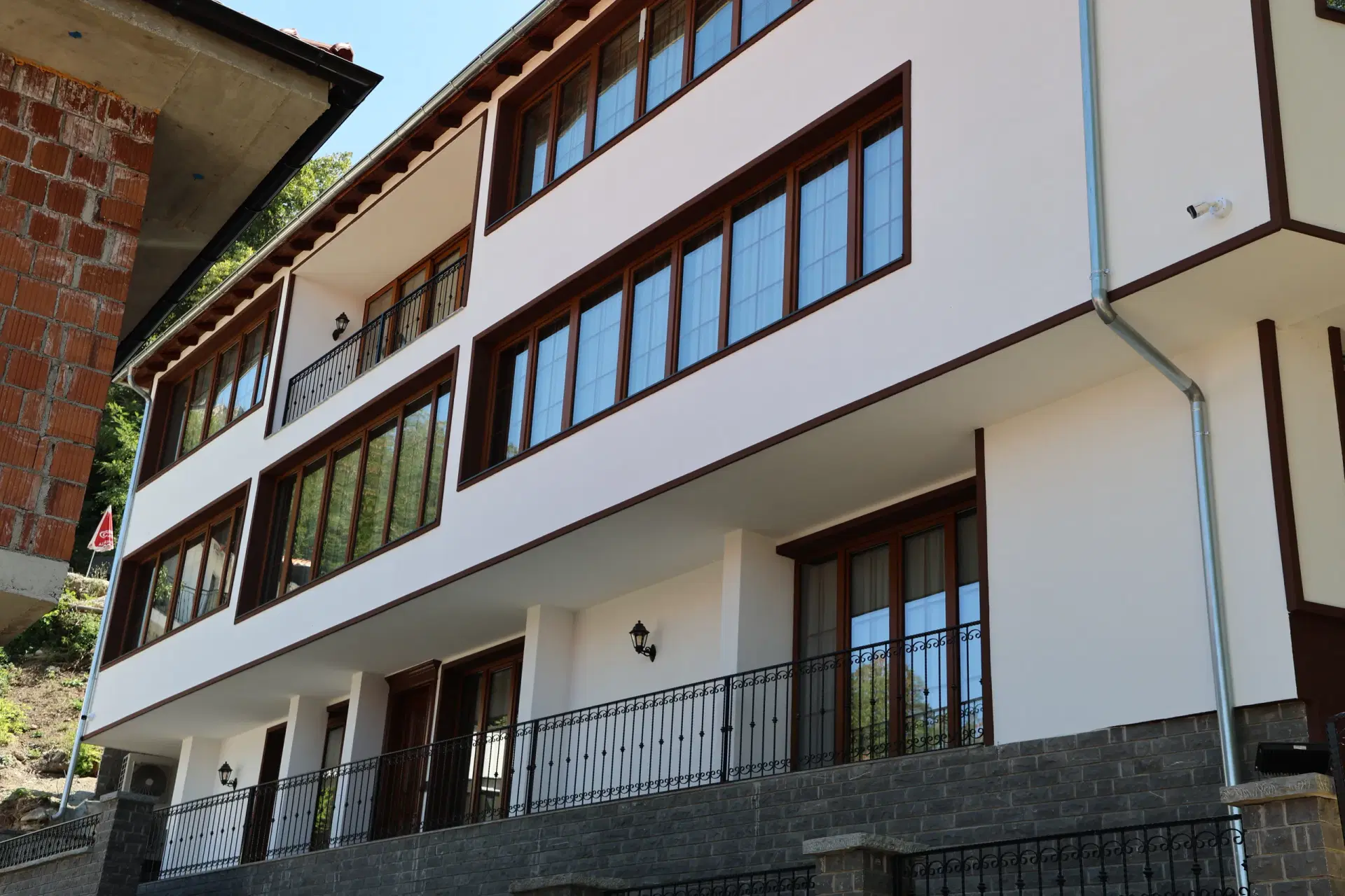 Timber window frames and wrought iron on the Nenkalaja facade